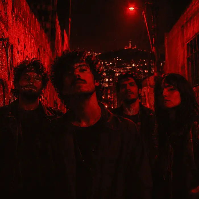 Os quatro integrantes da Maré Vermelha posando em um beco de Belo Horizonte à noite, com iluminação vermelha